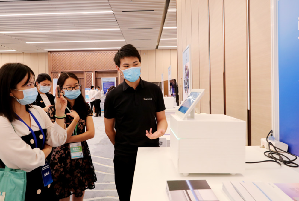 第四屆進(jìn)博會(huì)食品及農(nóng)產(chǎn)品展區(qū)、醫(yī)療器械及醫(yī)藥保健展區(qū)展前供需對接會(huì)的工作人員在介紹一臺(tái)測序儀展品